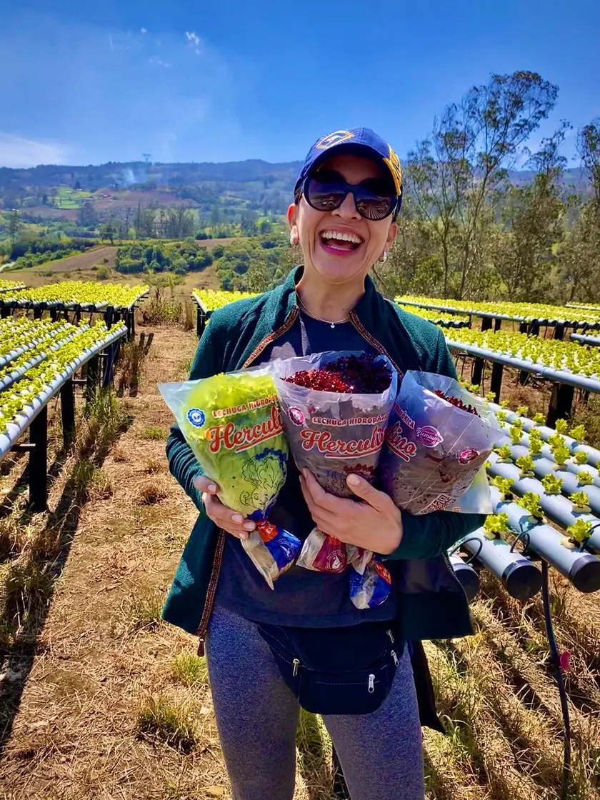 Clienta con tres bolsas de lechuga Herculina en la finca.